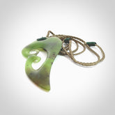 This photo shows a koru pendant carved from New Zealand Jade. The artist, Shaun Gardiner, has carved this beautifully. We provide this piece with an adjustable khaki cord. This is a fantastic work of art, we have one only.